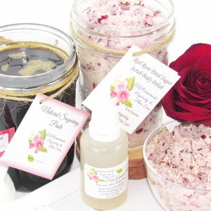 The bundle with an 8 oz jar filled with firm sugaring paste, a jar of Red Rose Petal Sugar Body Scrub, a small bottle of pure aloe vera, a pouch of cornstarch, an applicator, and a bowl showcasing the sugar scrub, garnished with a red rose bloom.