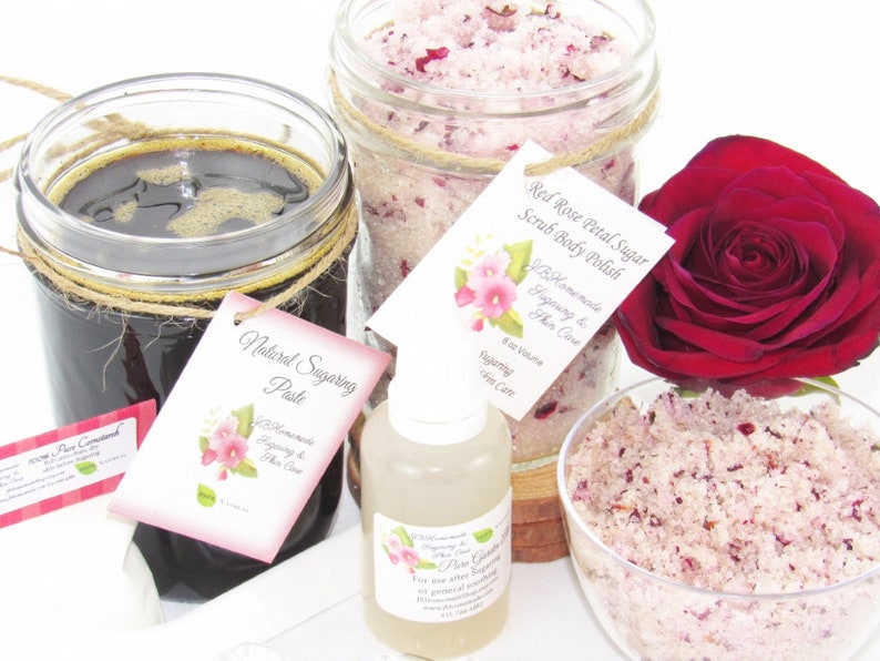 The bundle with an 8 oz jar filled with firm sugaring paste, a jar of Red Rose Petal Sugar Body Scrub, a small bottle of pure aloe vera, a pouch of cornstarch, an applicator, and a bowl showcasing the sugar scrub, garnished with a red rose bloom.