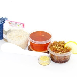 Our Home Sugaring Hair Removal Starter Kit includes 2 oz soft Sugaring Wax, Lemon Zest Sugar Scrub, Oatmeal Brown Sugar Scrub, Aloe Vera, cornstarch, denim strips, applicator. Lemon zest and slice, a bowl filled to the brim with dried lemon zest.
