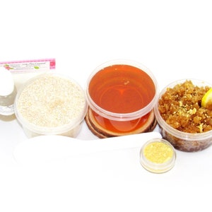 Our Home Sugaring Hair Removal Starter Kit includes 2 oz soft Sugaring Wax, Lemon Zest Sugar Scrub, Oatmeal Brown Sugar Scrub, Aloe Vera, cornstarch, denim strips, applicator. Lemon zest and slice, a bowl filled to the brim with dried lemon zest.