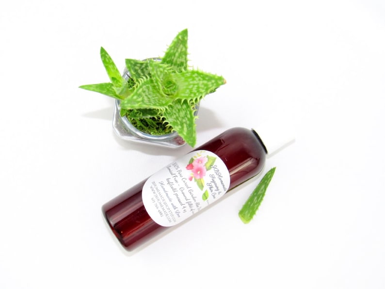 A 4 oz amber bottle of Pure Aloe Vera product, enriched and authentic, surrounded by fresh aloe vera leaf pieces, showcasing the natural ingredients and the premium quality of the product.