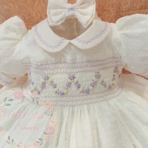 Front and back girl&#39;s smocking dress made in swiss ivory cotton dots fabric. Peter pan collar and cuffs.Bloomers and hair acc. incl