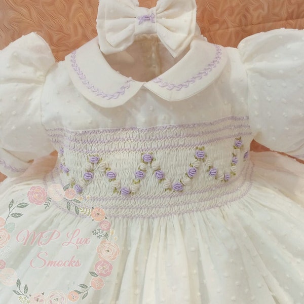 Front and back girl's smocking dress made in swiss ivory cotton dots fabric. Peter pan collar and cuffs.Bloomers and hair acc. incl