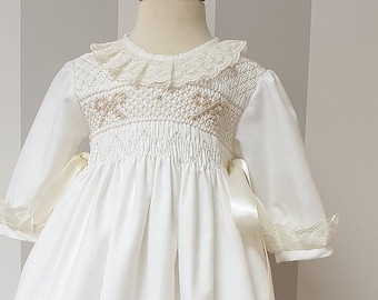 Stunning baby baptism dress gown, off white color, with beautiful smocked part handmade. Long sleeves. Sweety lace in the dress.Embroidery