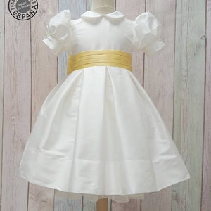T-length Flower Girl dress classic, ivory silk with silk sash and big bow. Puffy sleeves, peter pan collar. Girl elegant wedding dress