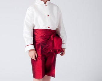 Boy suit in ivory silk and maroon. With three quarter pants with waistband loops. Mao collar with piping, covered buttons. Long sleeves