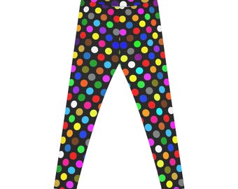 May include: Black leggings with a repeating pattern of multi-coloured polka dots. The dots are in various colours, including red, yellow, green, blue, pink, and white. The leggings are made of a stretchy fabric.