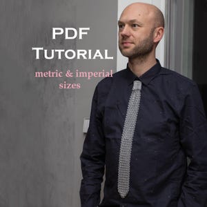 May include: A dark navy blue button-down shirt with small red dots, worn with a silver-toned chainmail necktie. The image includes white text that reads PDF TUTORIAL and pink text that reads metric & imperial sizes.