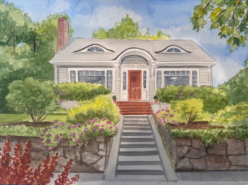 May include: Watercolor painting of a two-story house with a gray exterior, red door, and a chimney. The house has a gray roof with two oval windows. Landscaping includes bushes, flowers, and a stone wall.