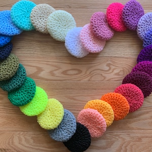 May include: A heart shape made of crocheted circles in various colours, including blue, green, yellow, orange, pink, purple, and white.