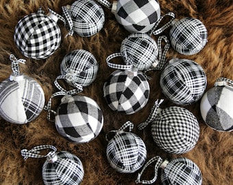 May include: A collection of black and white plaid Christmas ornaments. The ornaments are made of fabric and have a variety of patterns.