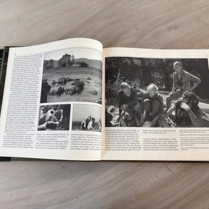May include: A black and white photo of a group of people standing on a rocky shore. The people are looking at the camera. The photo is from a book titled "The World of the Beluga".