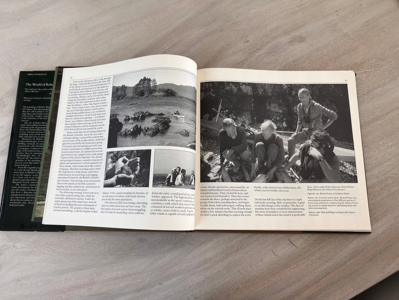 May include: A black and white photo of a group of people standing on a rocky shore. The people are looking at the camera. The photo is from a book titled "The World of the Beluga".