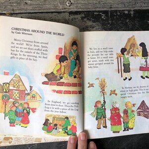 May include: An illustrated children's book page showing Christmas traditions around the world. The page features illustrations of children in Spain, Italy, England, and Norway, each celebrating Christmas in their own unique way. The text describes the traditions, such as leaving hay for the camels of the Three Kings in Spain, making a manger scene in Italy, caroling in England, and putting up sheaves of wheat for birds in Norway.