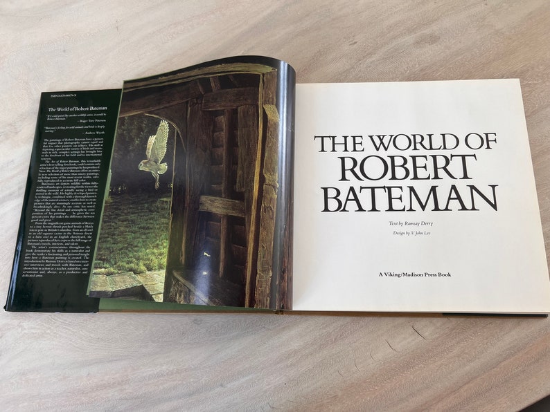 May include: A book titled "The World of Robert Bateman" with a white owl flying through a doorway on the cover.