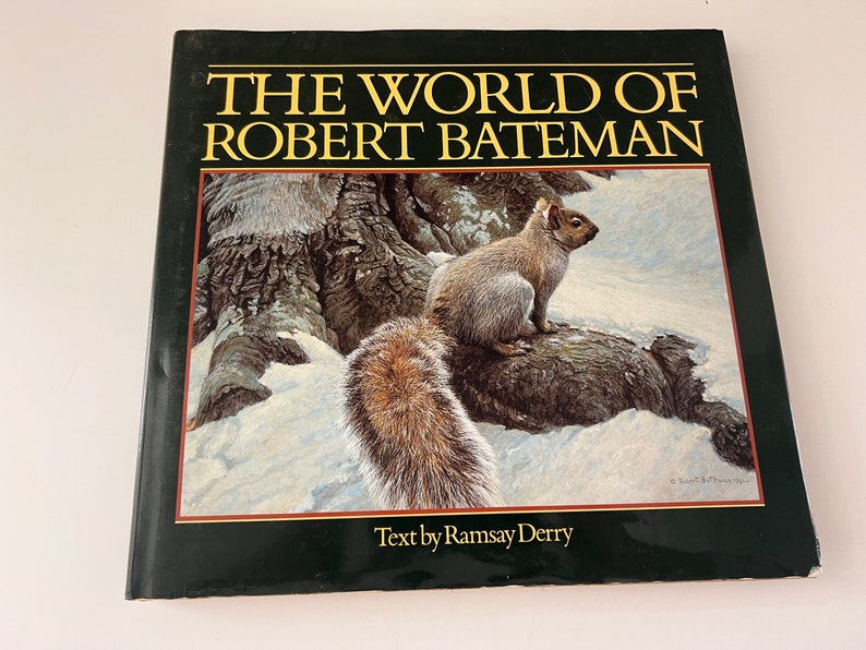 May include: The World of Robert Bateman book cover featuring a painting of a gray squirrel sitting on a tree branch in a snowy forest. The text on the cover reads "The World of Robert Bateman" and "Text by Ramsay Derry".