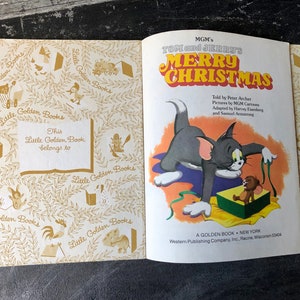 May include: A Little Golden Book featuring Tom and Jerry's Merry Christmas. The cover shows Tom and Jerry with a Christmas present. The book is a Golden Book, published by Western Publishing Company.