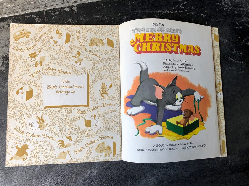 May include: A Little Golden Book featuring Tom and Jerry's Merry Christmas. The cover shows Tom and Jerry with a Christmas present. The book is a Golden Book, published by Western Publishing Company.