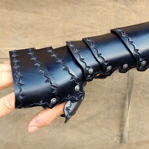 A leather demi gauntlet and bracer, shown being worn, and how they appear when combined with their cascading layers.