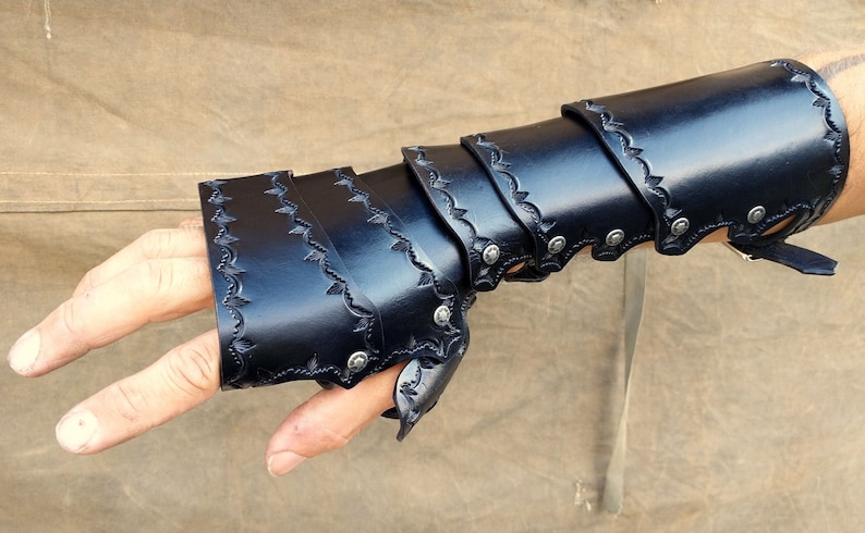 A leather demi gauntlet and bracer, shown being worn, and how they appear when combined with their cascading layers.