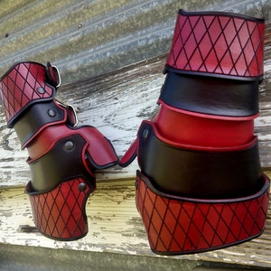 A set of leather gauntlets, dyed red & black in a diamond pattern, as requested for a Harley Quinn Cosplay.