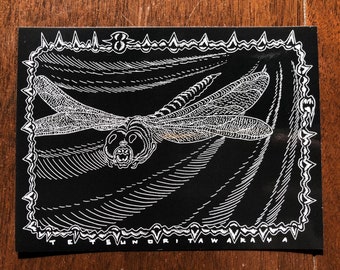 May include: Black and white illustration of a dragonfly with intricate details. The dragonfly is flying against a background of wavy lines. The image is framed with a border of spikes.