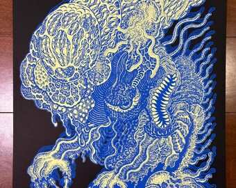 May include: A blue and yellow illustration of a creature with intricate patterns and details. The artwork features a black background and a unique, stylized design. The creature has a large head and a detailed body, with a textured appearance.