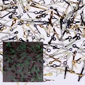 25 piezas de manecillas de reloj luminosas pintadas, piezas de manecillas de reloj negras y doradas para reparación de relojes.