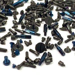 May include: A collection of various metal screws and bolts in shades of gray and blue. The fasteners are of different sizes and shapes, including flathead, hex head, and socket head screws. The image shows a close-up view of the hardware.