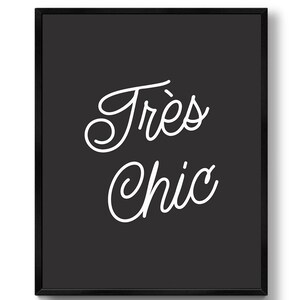 May include: Black and white typography print with the text "Tr&egrave;s Chic" in a cursive font.