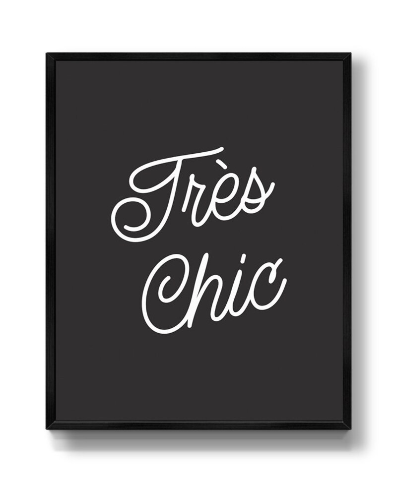 May include: Black and white typography print with the text "Tr&egrave;s Chic" in a cursive font.