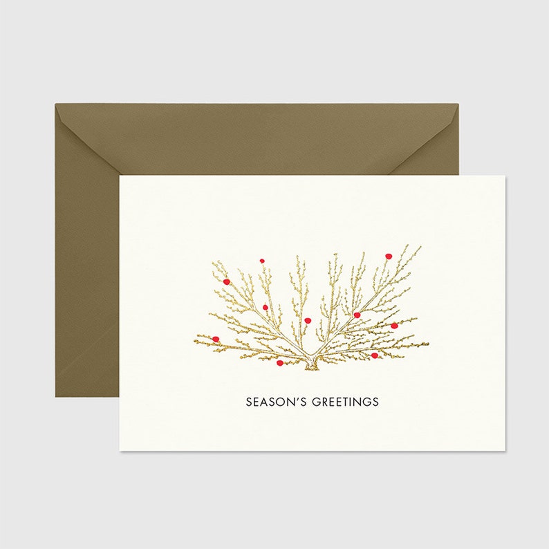 May include: A gold foil Christmas card with a stylized gold tree with red berries and the text "Season's Greetings".