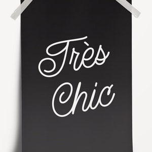 May include: A black and white poster with the text "Tr&egrave;s Chic" in a cursive font.