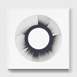 May include: A black and white abstract art print with a circular design. The center of the circle is white, and the outer edge is a dark gray with a radial pattern.
