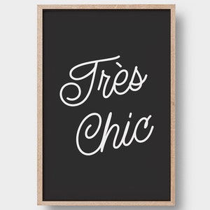 May include: Black and white framed print with the text "Tr&egrave;s Chic" in a cursive font.