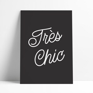 May include: Black and white typography print with the text "Tr&egrave;s Chic" in a cursive font.