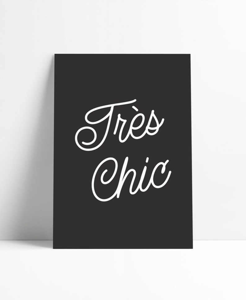 May include: Black and white typography print with the text "Tr&egrave;s Chic" in a cursive font.