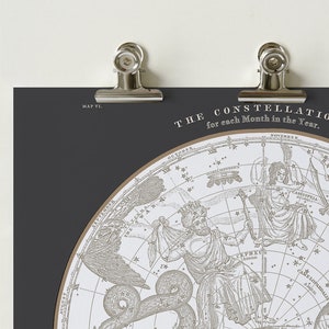 May include: A vintage style illustration of constellations for each month of the year. The illustration is in black and white and features the constellations of Cassiopeia, Cepheus, and Camelopardalis.