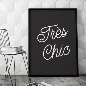 May include: Black and white framed print with the text "Tr&egrave;s Chic" in a cursive font.