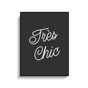 May include: Black and white typography print with the text "Tr&egrave;s Chic" in a cursive font.