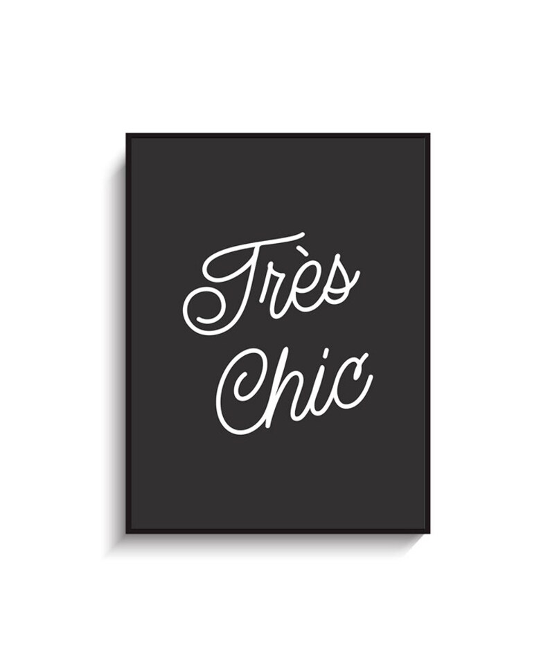 May include: Black and white typography print with the text "Tr&egrave;s Chic" in a cursive font.