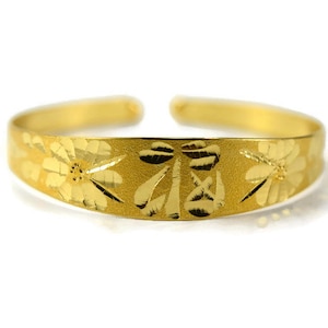 May include: A gold-colored ring with a floral design. The ring is made of metal and has a smooth finish.