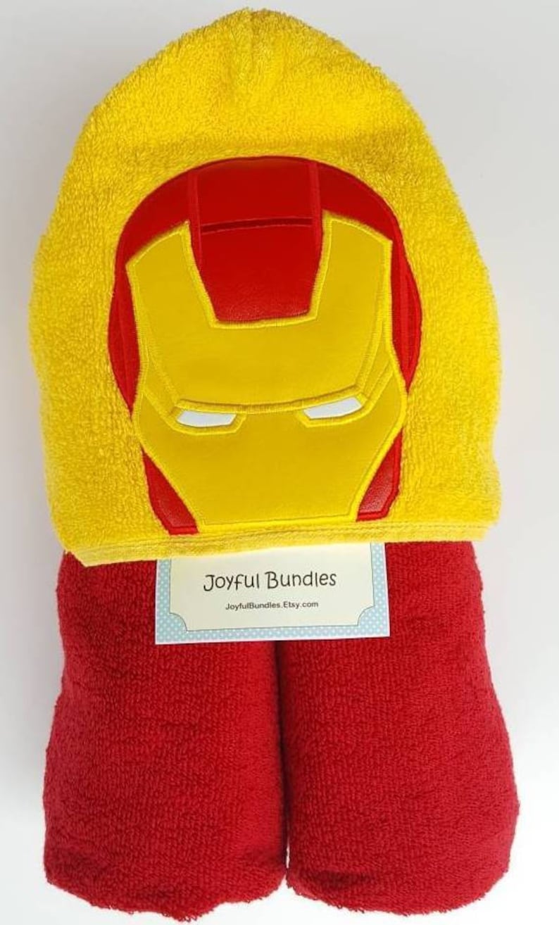 May include: Red and yellow hooded towel with an embroidered Iron Man face on the hood. The towel is folded and has a tag that says "Joyful Bundles JoyfulBundles.Etsy.com"