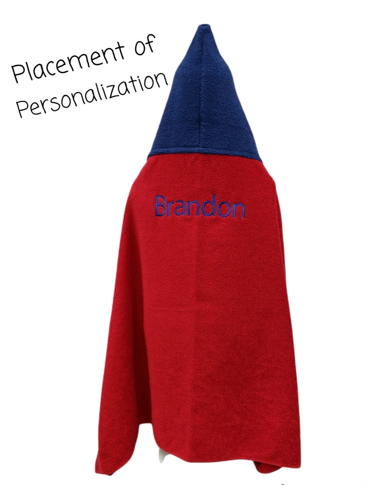 May include: Red hooded towel with a blue hood and the name "Brandon" embroidered on the front.