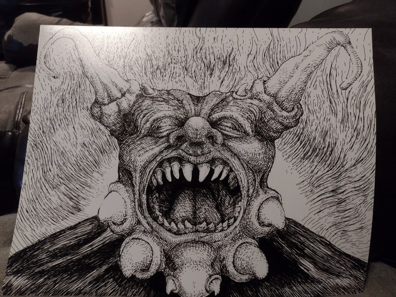 May include: A black and white pen and ink drawing of a grotesque, demonic creature with a large, open mouth and sharp teeth. The creature has a large, bulbous nose and two long, pointed ears.