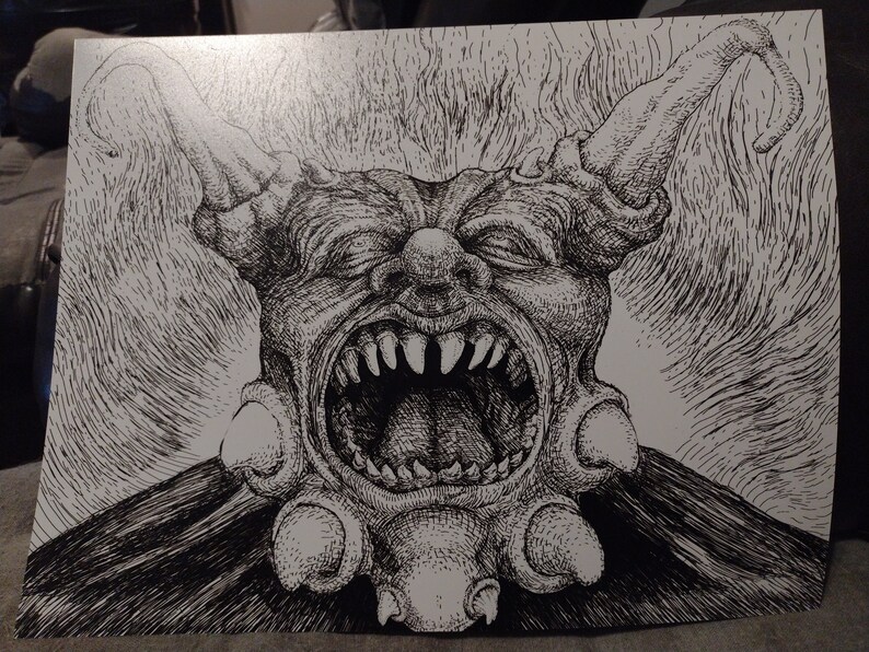 May include: A black and white pen and ink drawing of a grotesque, demonic creature with a wide open mouth, sharp teeth, and horns. The creature has a textured, detailed design.