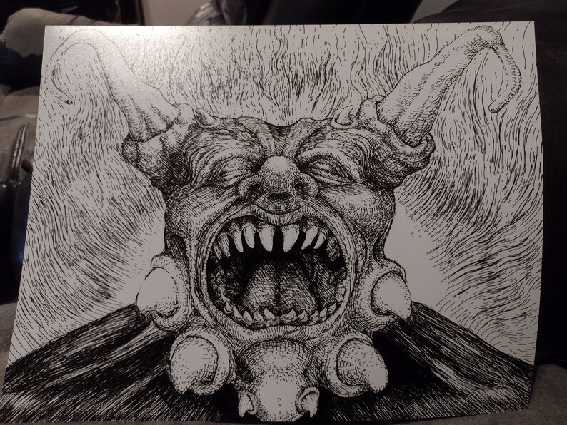 May include: A black and white pen and ink drawing of a grotesque, demonic creature with a large, open mouth and sharp teeth. The creature has horns and a large, bulbous nose.