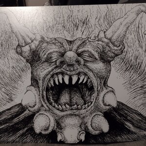 May include: Black and white ink drawing of a grotesque, demonic clown with a wide open mouth, sharp teeth, and horns. The clown is wearing a ruff collar with multiple round ornaments.