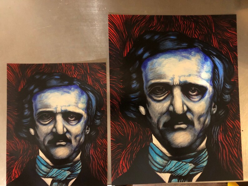 May include: Two different sized prints of a portrait of Edgar Allan Poe. The portrait is a close-up of his face and features a blue and black color scheme. The background is a red and black abstract design.