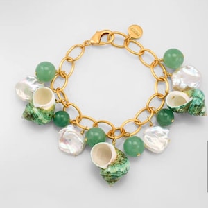 May include: Gold-toned bracelet featuring a chain design with green beads, white pearls, and green and white seashells. The bracelet has a lobster clasp closure and a small charm.